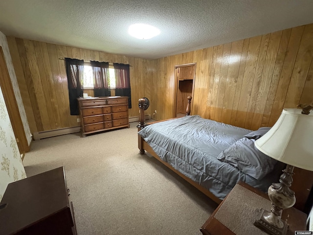 1501 N Federal Blvd, Riverton, WY 82501 - bedroom with a baseboard radiator, wooden walls, a textured ceiling, and carpet floors