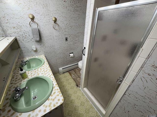 1501 N Federal Blvd, Riverton, WY 82501 - full bathroom featuring baseboard heating, double vanity, and a shower stall