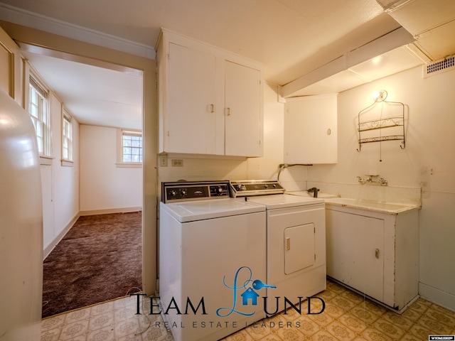719 E 4th St, Casper, WY 82601 - laundry area featuring cabinet space, independent washer and dryer, light floors, and light colored carpet
