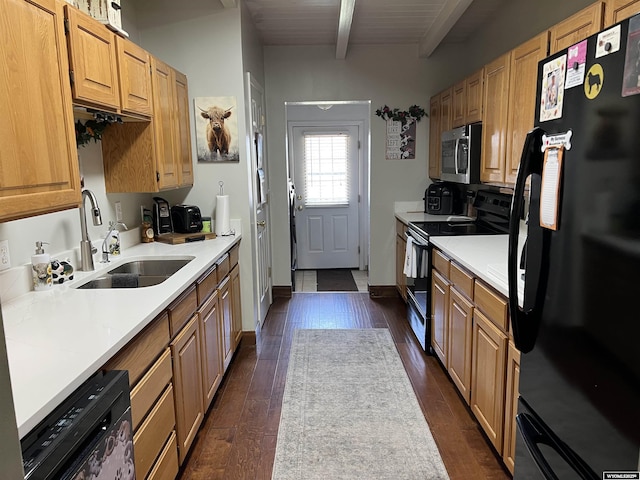 4359 Almy Rd Unit 107, Evanston, WY 82930 - kitchen featuring black appliances, dark wood-style floors, beamed ceiling, and light countertops