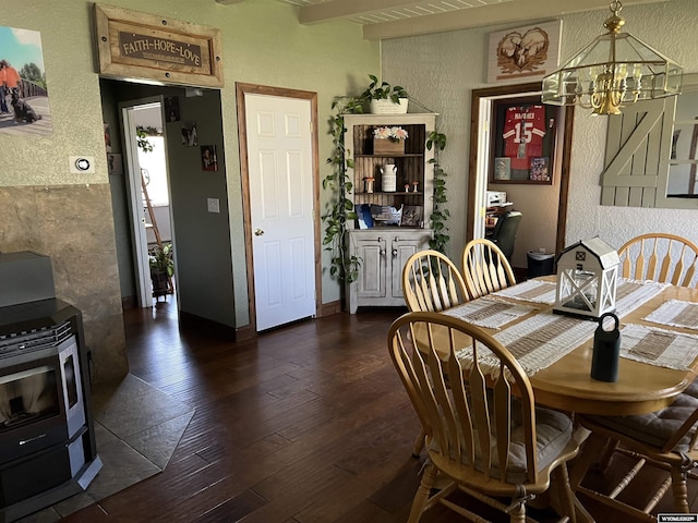 4359 Almy Rd Unit 107, Evanston, WY 82930 - dining room with a textured wall, a chandelier, dark wood-type flooring, and a wood stove