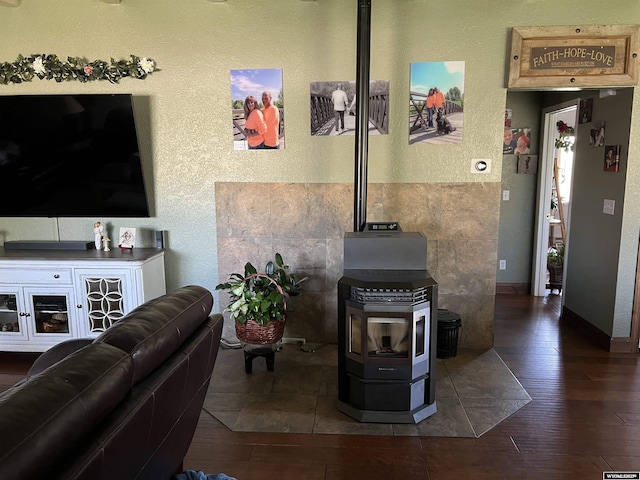 4359 Almy Rd Unit 107, Evanston, WY 82930 - living area with a textured wall, a wood stove, and wood finished floors