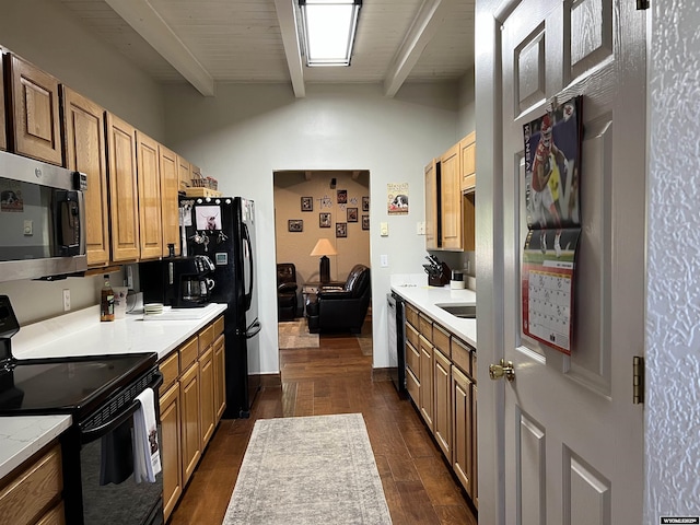 4359 Almy Rd Unit 107, Evanston, WY 82930 - kitchen featuring stainless steel microwave, black range with electric cooktop, light countertops, and dark wood-style floors