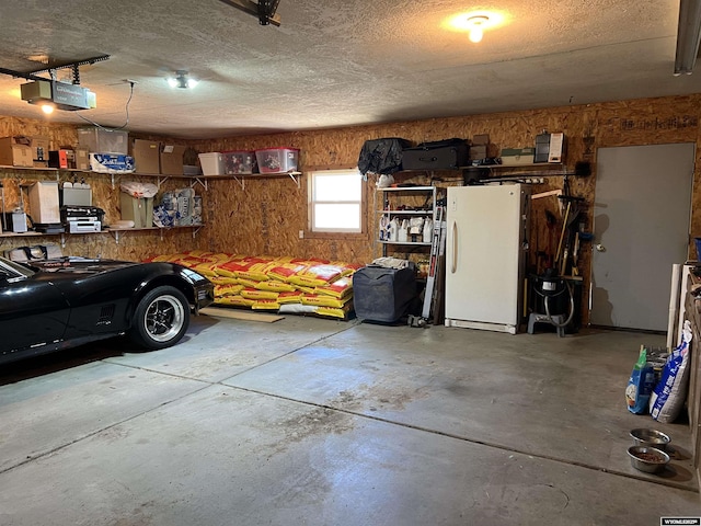 4359 Almy Rd Unit 107, Evanston, WY 82930 - garage featuring a garage door opener and freestanding refrigerator