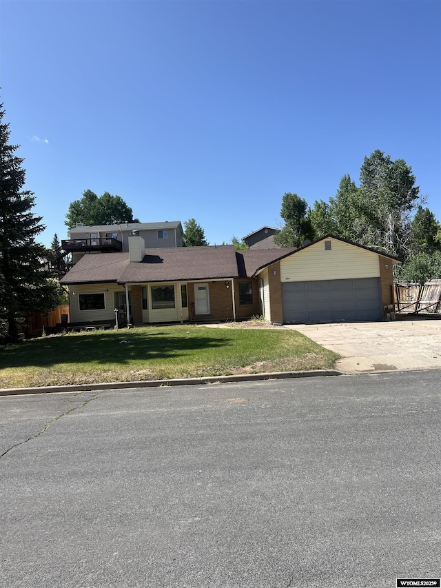 133 Shady Ln, Evanston, WY 82930 - view of front of property featuring an attached garage, a front lawn, and driveway