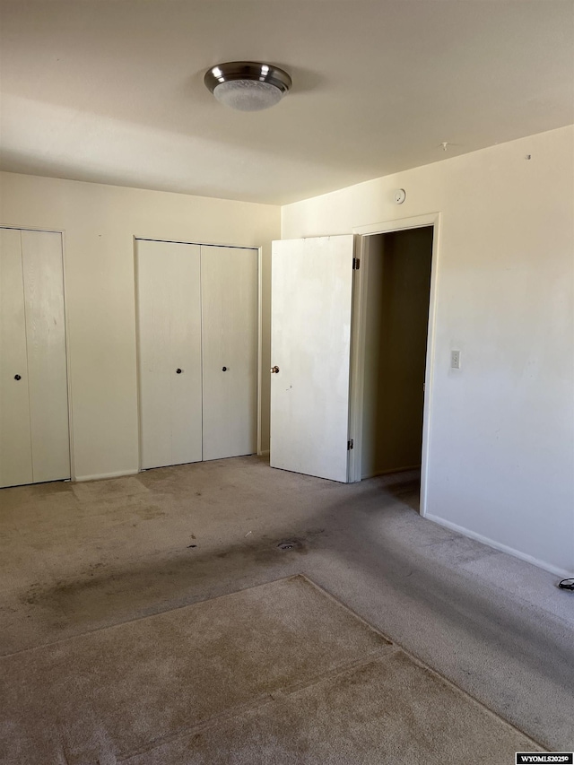 133 Shady Ln, Evanston, WY 82930 - unfurnished bedroom with carpet flooring and two closets