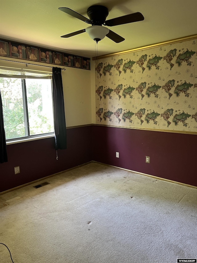 133 Shady Ln, Evanston, WY 82930 - unfurnished room featuring ceiling fan, carpet, and wainscoting
