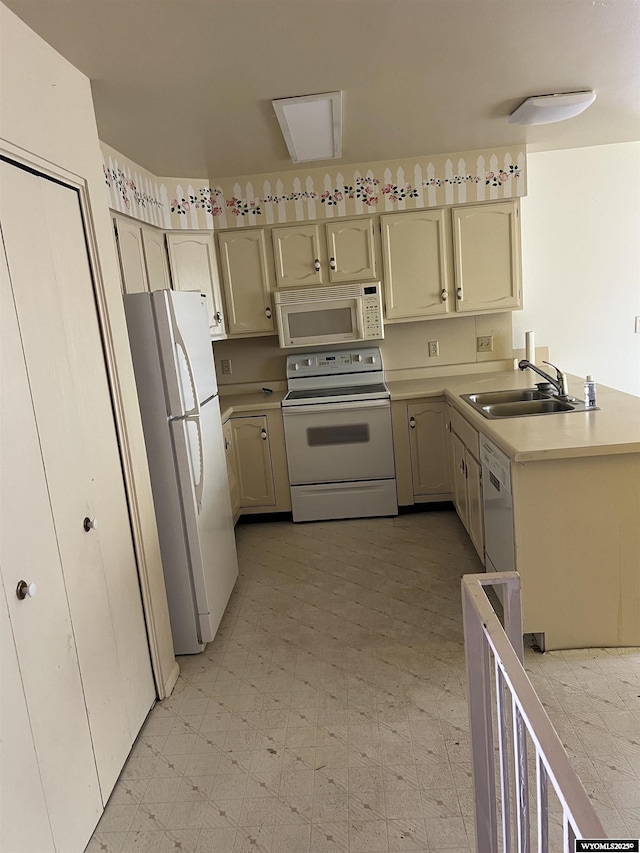133 Shady Ln, Evanston, WY 82930 - kitchen featuring white appliances, light floors, light countertops, and a peninsula
