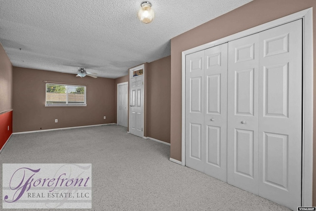 2240 E 17th St, Casper, WY 82609 - unfurnished bedroom featuring a textured ceiling, carpet, and a ceiling fan