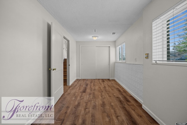 2240 E 17th St, Casper, WY 82609 - hallway featuring wood finished floors and a textured ceiling