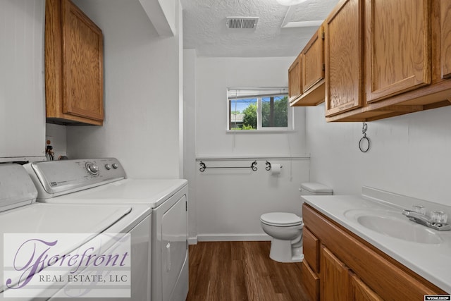 2240 E 17th St, Casper, WY 82609 - laundry area with washing machine and clothes dryer, dark wood finished floors, and a textured ceiling