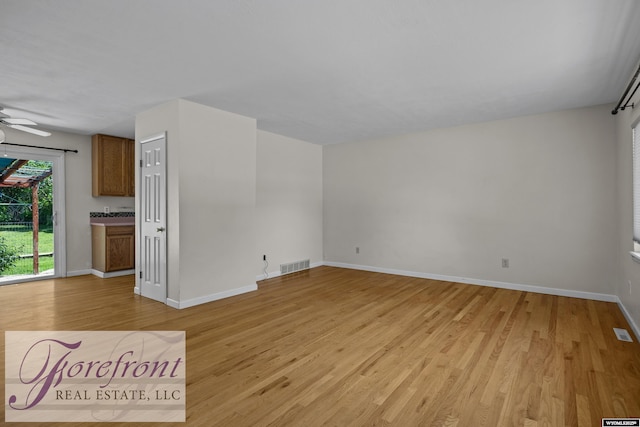 2240 E 17th St, Casper, WY 82609 - unfurnished living room featuring light wood-style flooring and ceiling fan