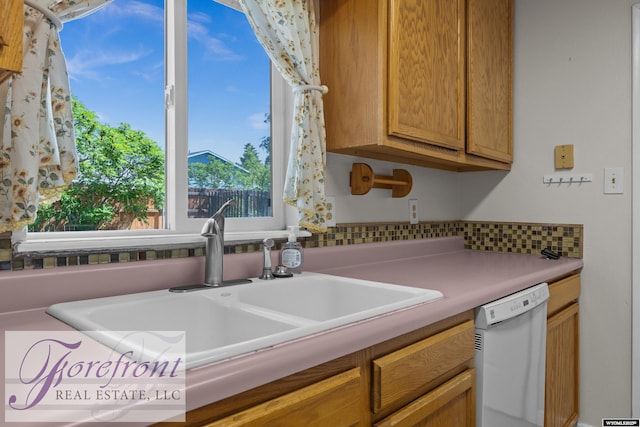 2240 E 17th St, Casper, WY 82609 - kitchen featuring white dishwasher, light countertops, and decorative backsplash