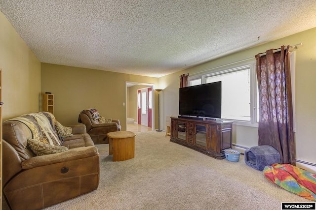 2203 W 42nd St, Casper, WY 82604 - carpeted living area featuring a textured ceiling and a baseboard heating unit