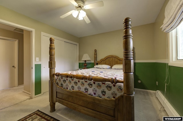 2203 W 42nd St, Casper, WY 82604 - bedroom with light carpet, baseboard heating, a ceiling fan, and a closet