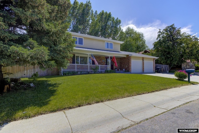 2203 W 42nd St, Casper, WY 82604 - traditional-style house with covered porch, an attached garage, driveway, and brick siding