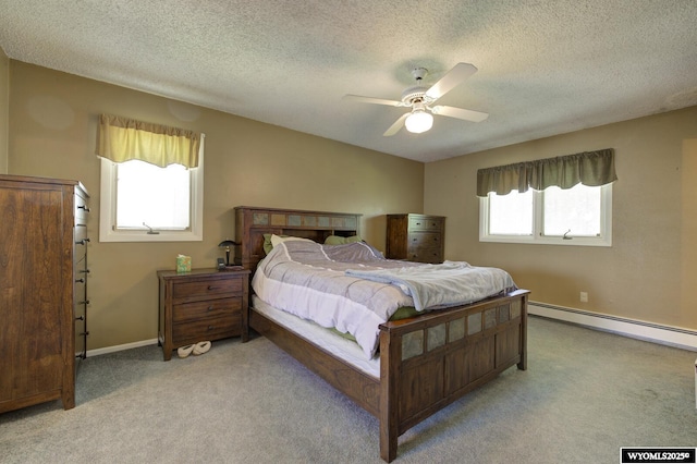 2203 W 42nd St, Casper, WY 82604 - bedroom featuring baseboard heating, light carpet, multiple windows, and a textured ceiling