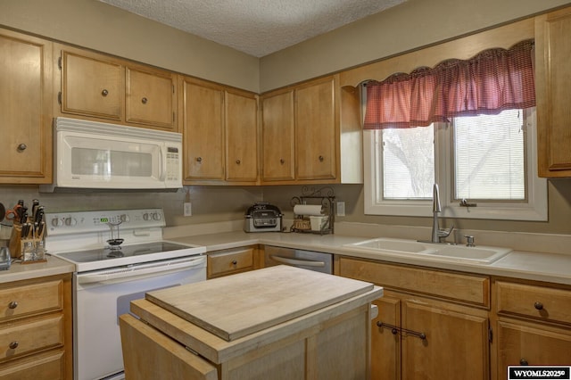 2203 W 42nd St, Casper, WY 82604 - kitchen featuring white appliances, light countertops, a kitchen island, and a textured ceiling