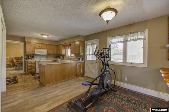 2203 W 42nd St, Casper, WY 82604 - workout room with a textured ceiling, light wood-style flooring, and baseboard heating