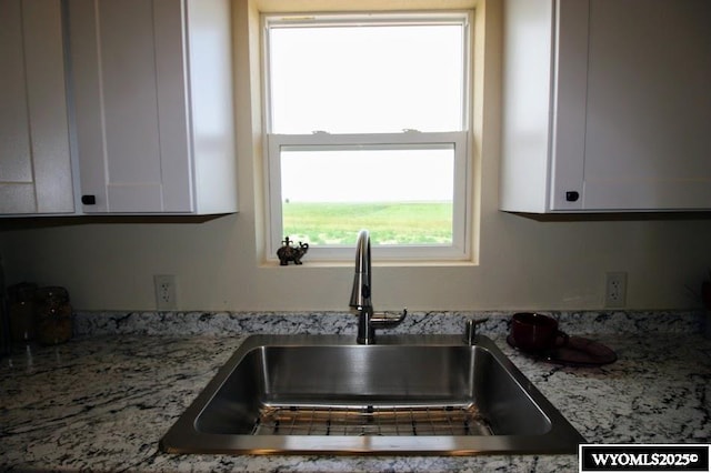 380 S-A Rd, Morrill, NE 69358 - kitchen with healthy amount of natural light, white cabinets, and light stone countertops