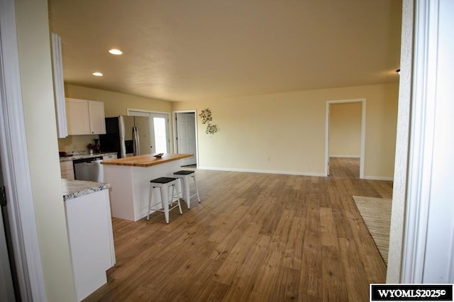 380 S-A Rd, Morrill, NE 69358 - kitchen with appliances with stainless steel finishes, wood counters, a center island, white cabinets, and light wood-type flooring