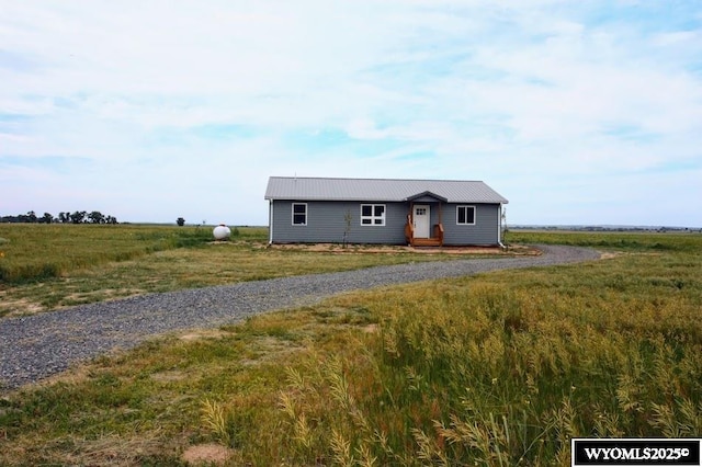 380 S-A Rd, Morrill, NE 69358 - ranch-style house with a metal roof and gravel driveway