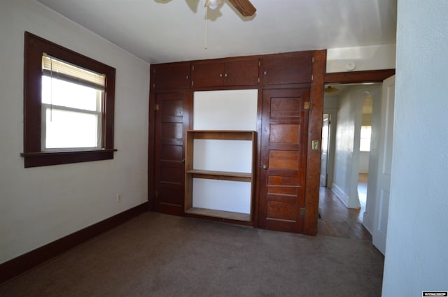 2142 W C St, Torrington, WY 82240 - unfurnished room featuring ceiling fan, plenty of natural light, carpet, and arched walkways