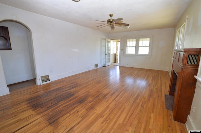 2142 W C St, Torrington, WY 82240 - spare room with light wood-style flooring, arched walkways, and ceiling fan