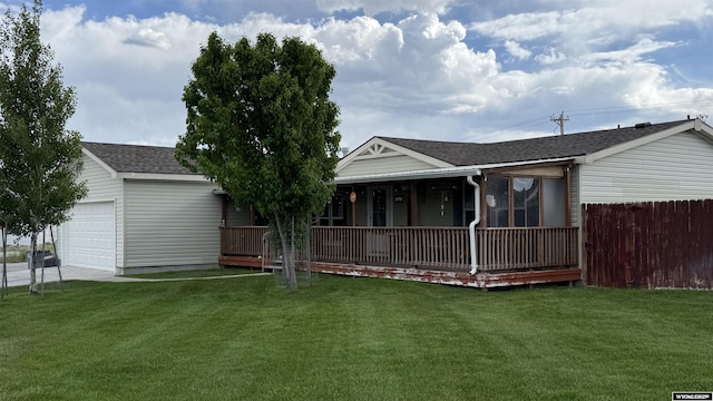 2108 Energy, Rawlins, WY 82301 - rear view of house featuring an attached garage, roof with shingles, and a porch