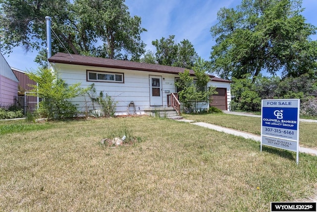 1220 Bon Ave, Casper, WY 82609 - ranch-style house with a garage and a front yard