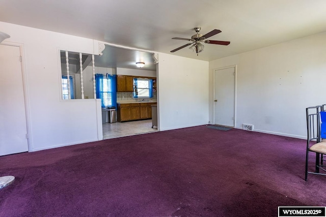 1220 Bon Ave, Casper, WY 82609 - unfurnished living room with carpet and a ceiling fan
