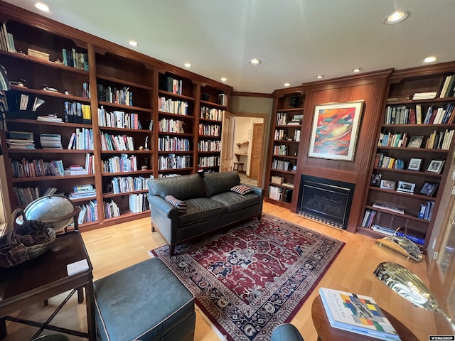 4251 Valley Grn, Riverton, WY 82501 - sitting room with bookshelves, wood finished floors, recessed lighting, a fireplace, and built in shelves