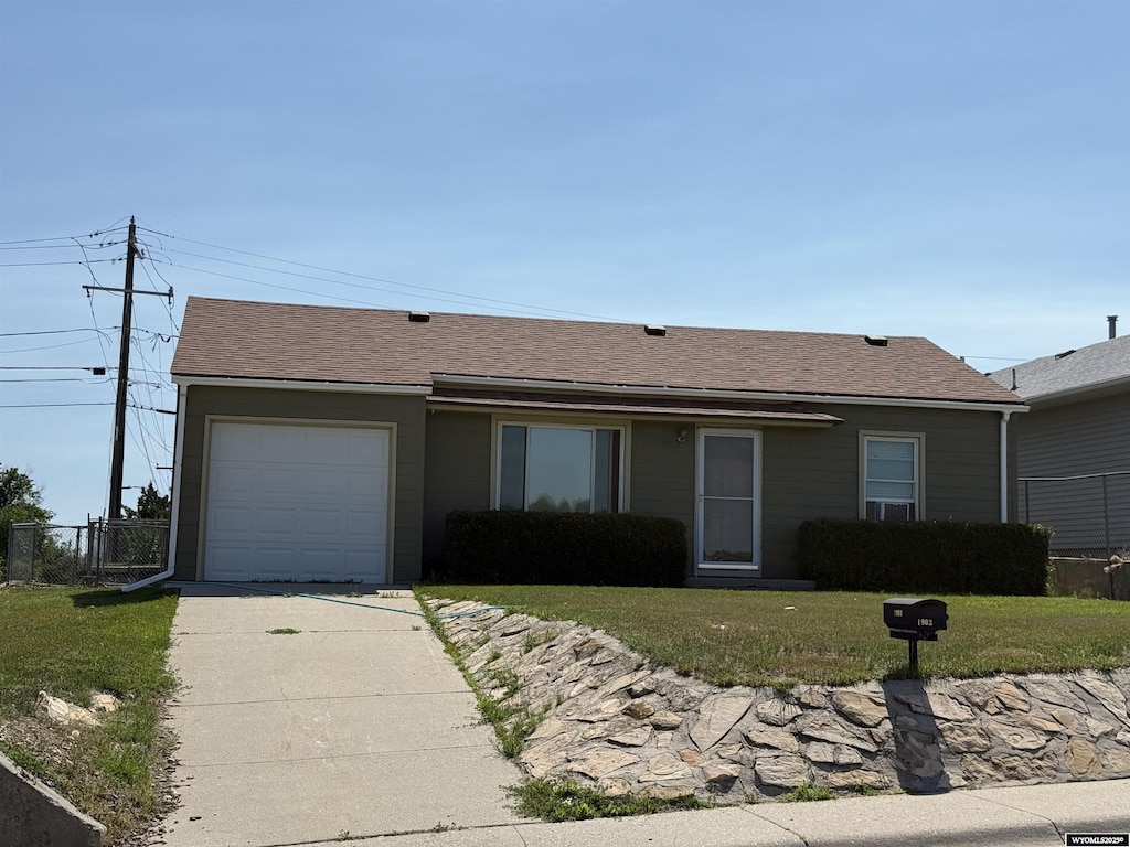1903 Oakcrest, Casper, WY 82609 - ranch-style house with an attached garage, concrete driveway, and a shingled roof