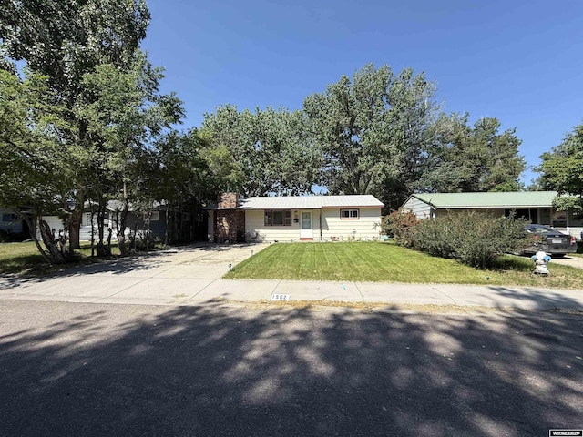 1502 Kearney Ave, Casper, WY 82604 - view of front facade with a front yard, a chimney, and driveway