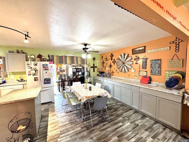 327 S Iowa Ave, Guernsey, WY 82214 - dining space featuring wood finished floors, a ceiling fan, and a textured ceiling