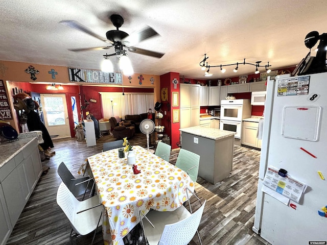 327 S Iowa Ave, Guernsey, WY 82214 - dining area with dark wood-style flooring, a ceiling fan, and a textured ceiling