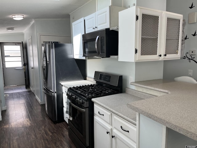 703 Randolph St, Rock Springs, WY 82901 - kitchen featuring black appliances, ornamental molding, white cabinets, light countertops, and dark wood finished floors