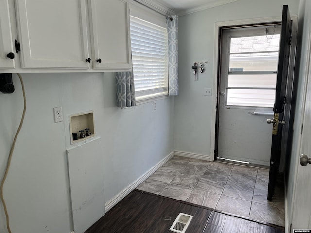 703 Randolph St, Rock Springs, WY 82901 - laundry area with cabinet space, washer hookup, crown molding, and plenty of natural light