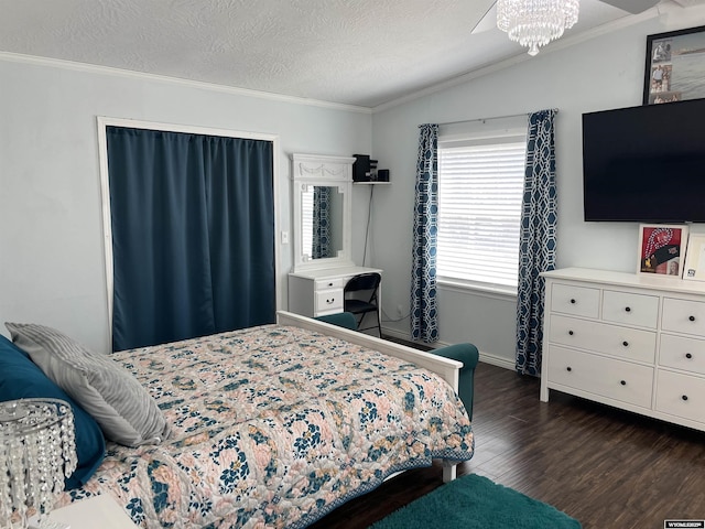 703 Randolph St, Rock Springs, WY 82901 - bedroom featuring dark wood-type flooring, crown molding, a textured ceiling, and a chandelier