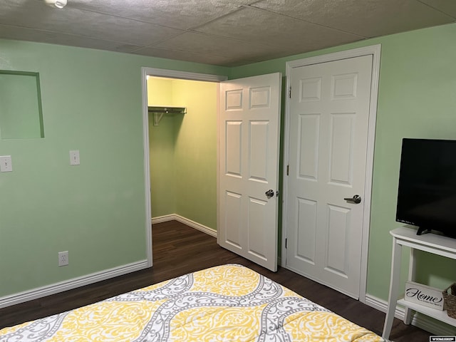 703 Randolph St, Rock Springs, WY 82901 - unfurnished bedroom with dark wood-style floors, a closet, and a walk in closet