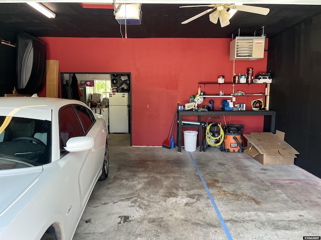703 Randolph St, Rock Springs, WY 82901 - garage with a garage door opener, freestanding refrigerator, a heating unit, ceiling fan, and a workshop area