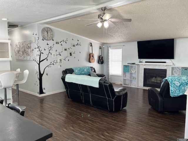 703 Randolph St, Rock Springs, WY 82901 - living area featuring a textured ceiling, wood finished floors, ceiling fan, crown molding, and a fireplace with flush hearth