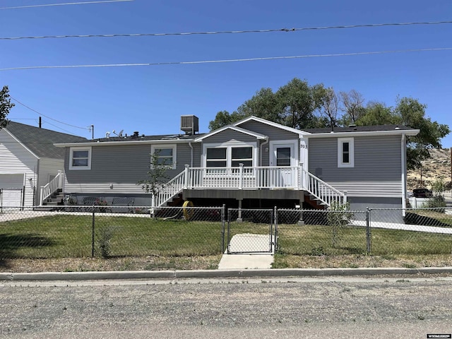 703 Randolph St, Rock Springs, WY 82901 - manufactured / mobile home with a fenced front yard, a deck, stairway, and a gate