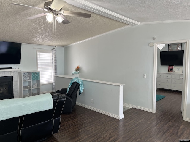 703 Randolph St, Rock Springs, WY 82901 - living area with a textured ceiling, wood finished floors, a ceiling fan, ornamental molding, and a tile fireplace