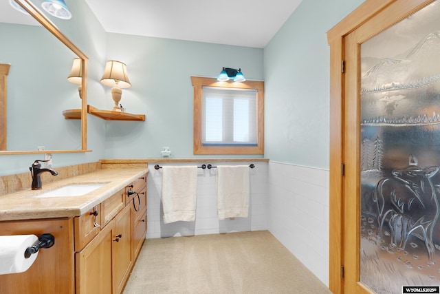 966 Mill Creek Rd, Evanston, WY 82930 - bathroom with vanity, wainscoting, and tile walls