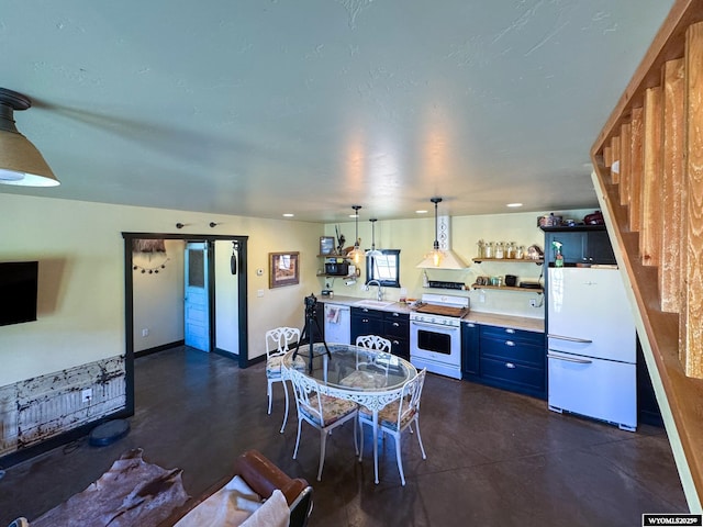 18 Lewis Dr, Lander, WY 82520 - kitchen with white appliances, concrete floors, blue cabinets, light countertops, and open shelves