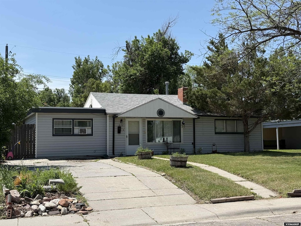 377 N Minnesota, Casper, WY 82609 - view of front facade featuring concrete driveway and a chimney