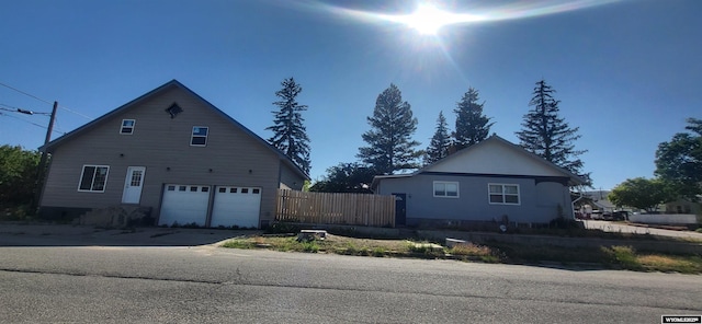 222 E Maple St, Rawlins, WY 82301 - view of side of property featuring an attached garage and driveway