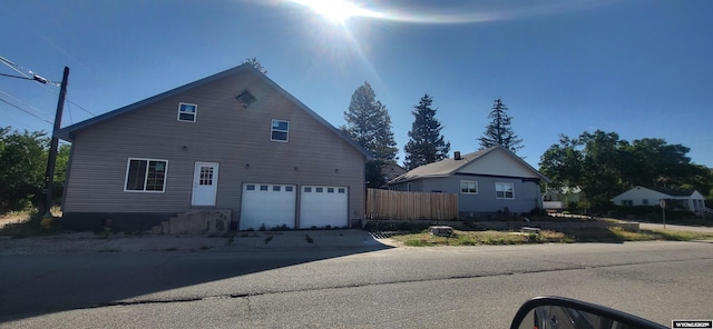 222 E Maple St, Rawlins, WY 82301 - view of side of property with a garage and concrete driveway