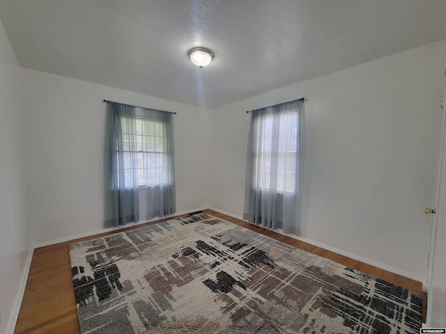 1031 Mckinley Ave, Rock Springs, WY 82901 - unfurnished room featuring wood finished floors and healthy amount of natural light